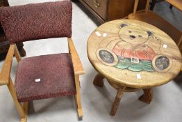A vintage child's rocking chair and novelty occasional table