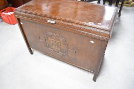 An early to mid 20th Century oak and ply bedding box having applique decoration and deco style