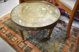 An Edwardian mahogany oval back bedroom chair and Egyptian themed brass topped coffee table