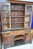 A Victorian kitchen dresser (probably a marriage) with part glazed top section over sideboard