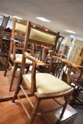 A pair of late Victorian or Edwardian spindle back salon armchairs