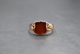 An 8ct rose gold signet ring having a vacant carnelian cartouche in a bezel mount to moulded