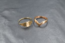 A 9ct gold heart motif signet ring, having a central diamond chip and scroll decoration to