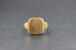A 9ct gold signet ring, the square panel having a vacant corner with line engraving in a sunray
