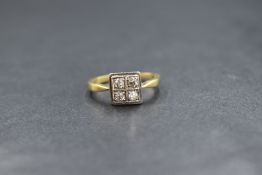 An 18ct gold diamond set cluster ring, the four old cut diamonds in a 'quad' cluster, marked 18ct,