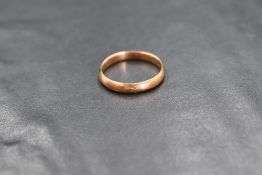 A 9ct gold band, of plain rounded form, marked 375, ring size J-K, 1.6g