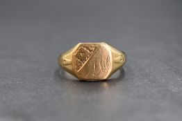 A 9ct gold signet ring, the square panel having 'MA' engraved with floral decoration to one corner