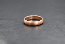 A 9ct rose gold band, of plain rounded form, marked 375, ring size M, 3.8g