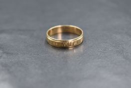 A 9ct gold band, having a central textured band, marked 375, ring size K-L, 1.3g