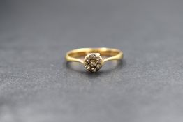 An 18ct gold diamond daisy cluster ring of dainty form, the seven old cut diamonds in a pave