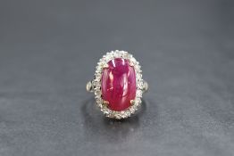 A yellow metal presumed gold Myanmar (Burmese) ruby and diamond set cluster ring, the oval