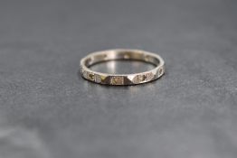 A 9ct white gold sapphire set band, the textured band having round white sapphires, marked 9ct, ring