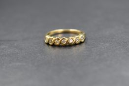 An 18ct gold diamond set half eternity ring, the seven round brilliant cut diamonds in an infinity