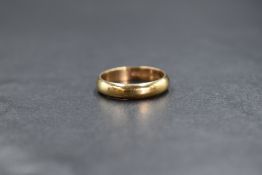A 9ct gold band, of plain rounded form, marked 375, ring size J-K, 2.6g