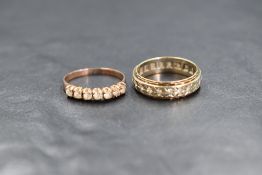 A 9ct gold sapphire set band, having a white gold central band set with round cut white sapphires,