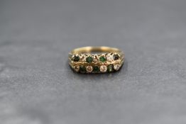 A 9ct gold emerald and cubic zirconia set band, having two rows of alternating round cut emeralds