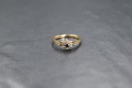 A 9ct gold sapphire and diamond floral cluster ring of delicate form having a small central sapphire