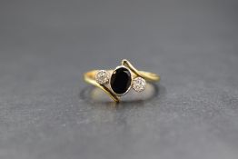 An 18ct gold sapphire & diamond ring, the central oval sapphire of approx 0.5ct in a bezel mount