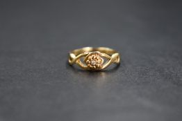 A 9ct gold diamond set ring, the central round brilliant cut diamond in a floral setting, in a