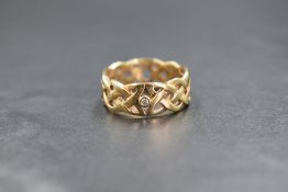 A 9ct gold band, of pierced Celtic knot motif, marked 375, ring size M, 4.2g