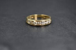 A 9ct gold cubic zirconia set band, the seven round brilliant cut cubic zirconia in a channel