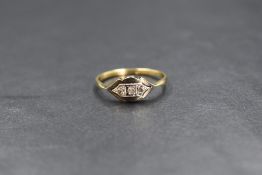 A yellow metal Edwardian three stone diamond ring stamped 18ct & plat, the three small pave set