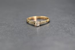 A 9ct gold diamond solitaire ring having a 0.064ct brilliant cut diamond in a four claw mount with