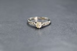An 18ct white gold diamond set solitaire ring, the round brilliant cut diamond measuring