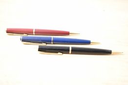 Three Parker 17 propelling pencils in black, red, and blue.