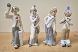 A group of four Casades Spanish porcelain clown figures to include two band members, a violinist and