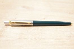 A Parker 45 ballpoint pen dark green with flighter cap having gold trim caps