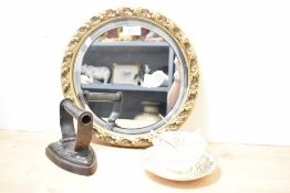 A vintage circular mirror having a molded frame with carved style foliage details sold along with