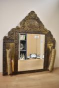 An early 20th-century Dutch-style brass-mounted mirror and brush set, featuring an arched top, a