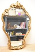 A vintage Atsonea gilt resin wall mirror, featuring an ornate Rococo-style frame with rose-formed