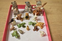 An assortment of small porcelain animal studies including penguin, cats and frogs.