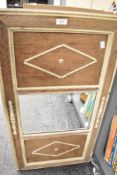 A large late 20th-century panelled wooden wall mirror, having a light wood finish and decorative