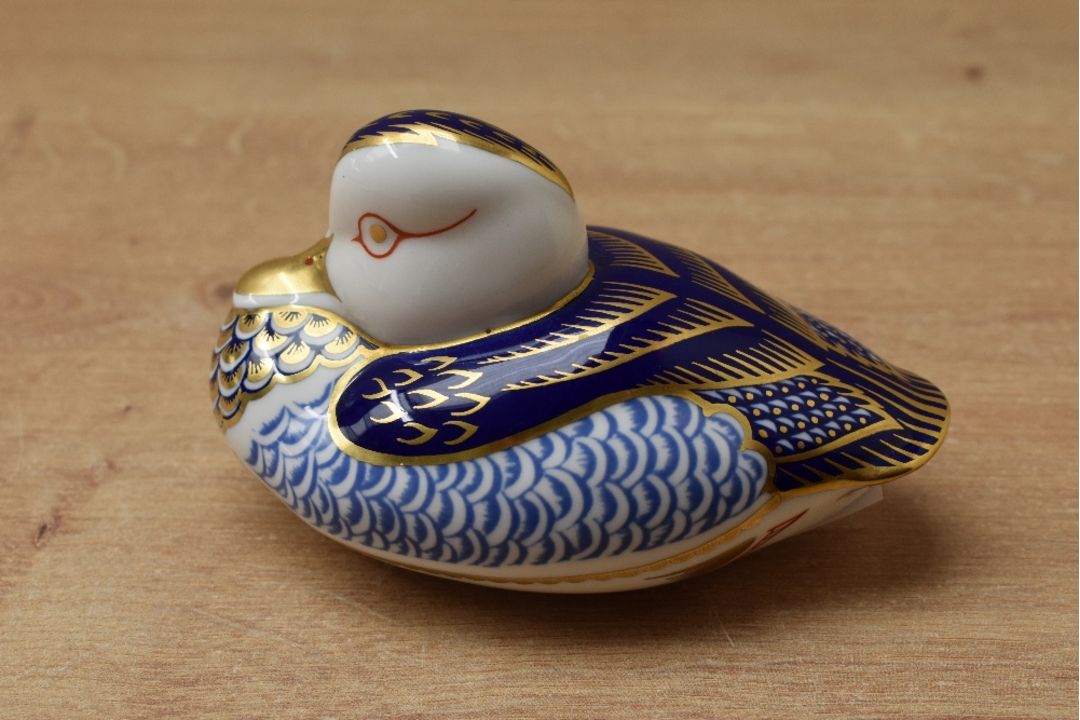 A Royal Crown Derby bone china duck paperweight, having Imari style decoration and a gold coloured - Image 2 of 3