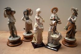 A group of six Capodimonte style figures and figurines, in varied floral and fruit holding poses,
