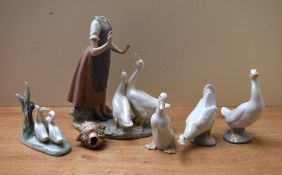 A group of five Nao by Lladro porcelain studies including 'Girl Feeding Geese' having damaged