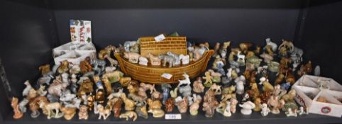 A vast selection of Wade English porcelain whimsies to include a rhinoceros, crocodile, panda,