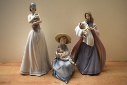 A group of three Nao by Lladro porcelain figurines comprising 'Mother's Touch' model number 1300, 'A
