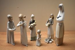 A group of six Nao by Lladro and similar porcelain figurines to include 'Girl Stretching' and '