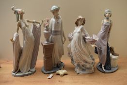 A group of four Lladro porcelain figurines comprising 'Grand Dame' model number 1568, 'Lady Grand