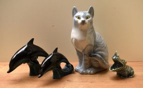 Two Poole Pottery blue glaze dolphin studies sold together with a Wade Irish porcelain rhinoceros
