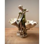A late 19th century Royal Dux porcelain centrepiece, modelled as a classically dressed maiden