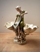 A late 19th century Royal Dux porcelain centrepiece, modelled as a classically dressed maiden
