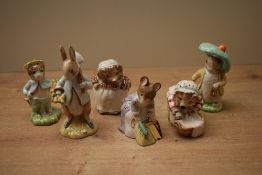 A group of six Beswick Pottery Beatrix Potter characters including 'Miss Tiggy Winkle' having gold
