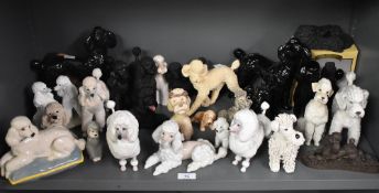 A large assortment of Royal Doulton and similar dog studies, predominantly poodles, comprising