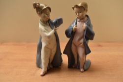 Two Nao by Lladro porcelain figurines comprising 'My Daddy's Coat' model number 1316 and 'Just