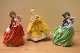 A group of three Royal Doulton bone china figurines comprising 'Autmun Breezes' HN 1913, 'The